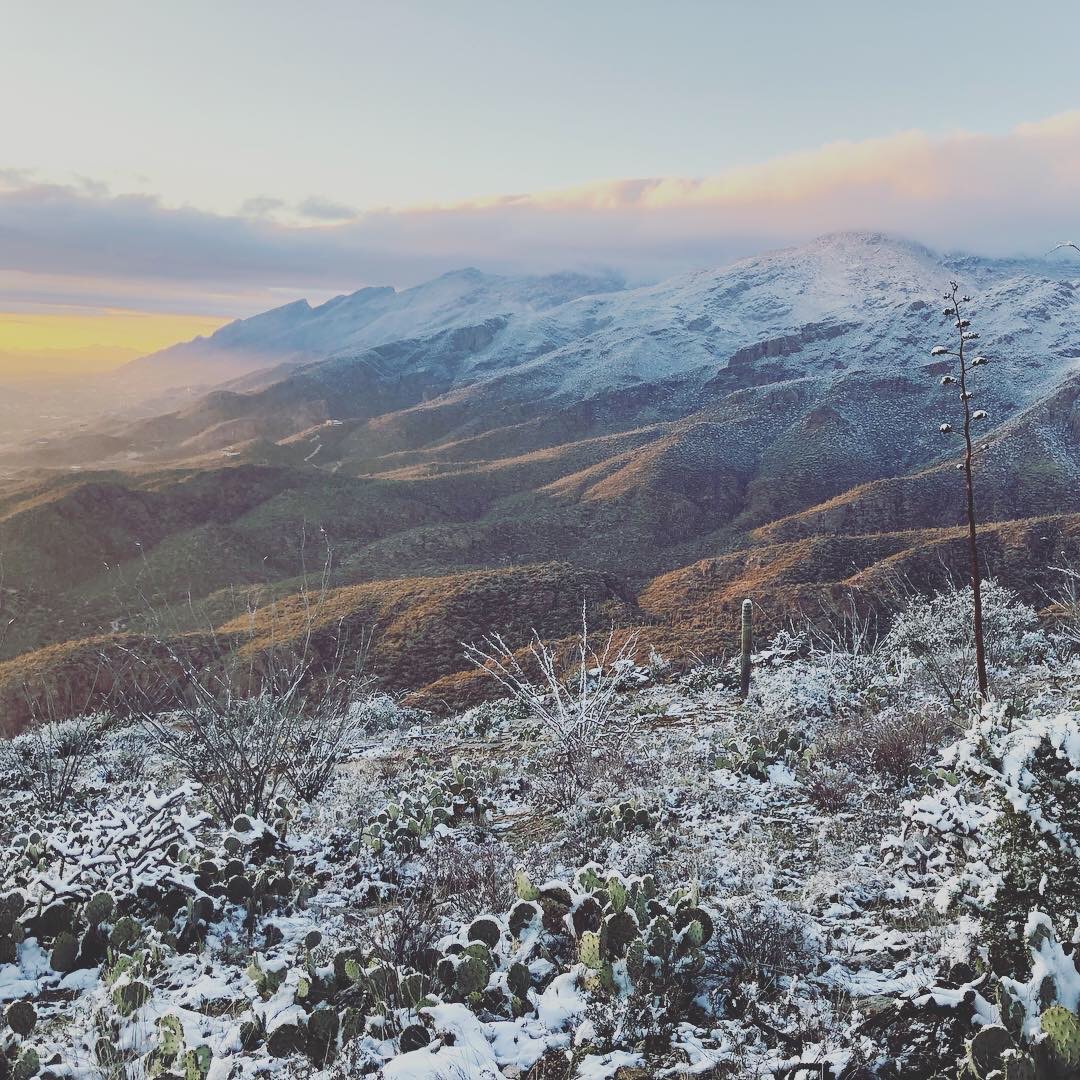 Snowy desert mountains at sunset